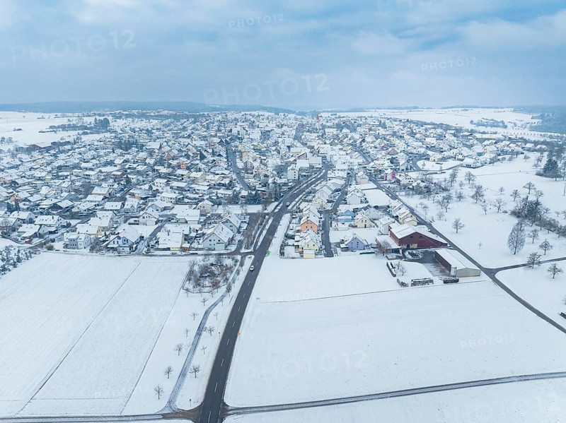 Winter landscape with snow-covered town and surrounding fields, Deckenpfronn, Böblingen district, Germany