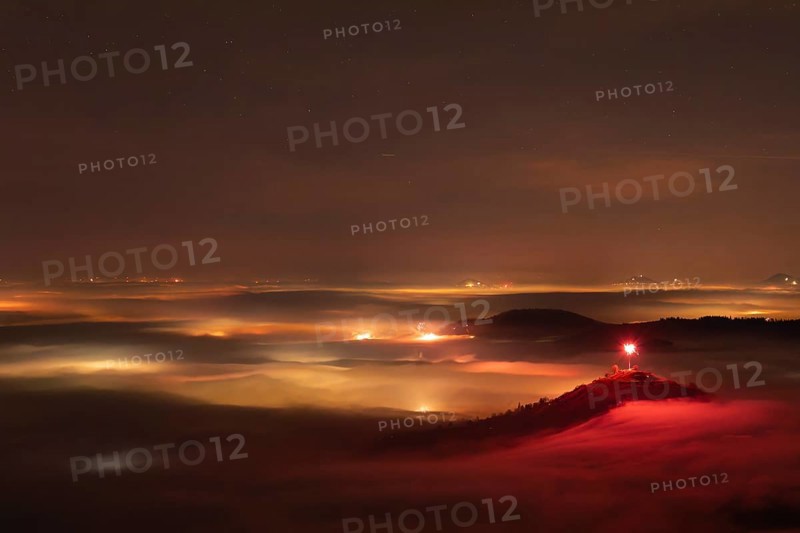 New Year's Eve fireworks 2024 on the Breitenstein, Swabian Alb near Ochsenwang. Sea of fog in the foothills of the Alb. View of the Drei Kaiserberge near Göppingen. In the foreground the Limburg and the Aichelberg