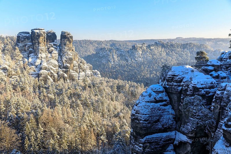 Winter view from the Bastei bridge into the Wehlgrund with Neurathener Felsenburg, Gansfelsen, beehive and locomotive, Saxon Switzerland, Saxony, Germany