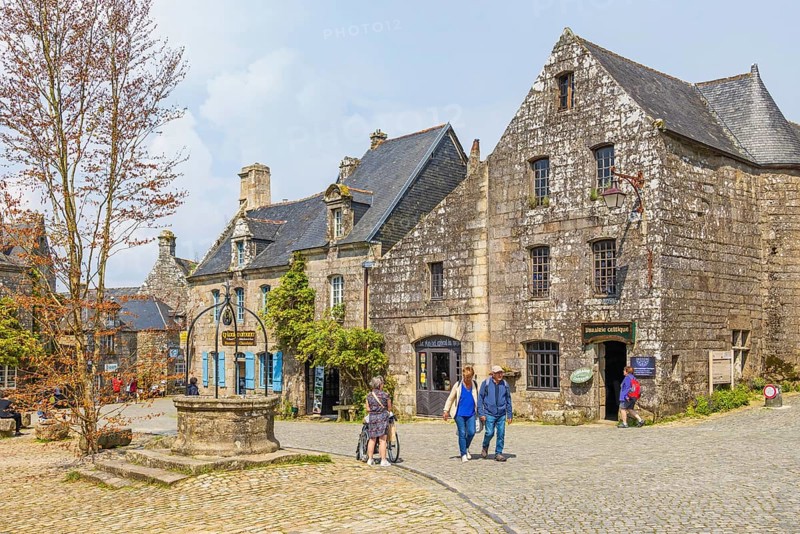 City square with tourist and stone houses in the old town Locronan, Locronan, Bretagne, France