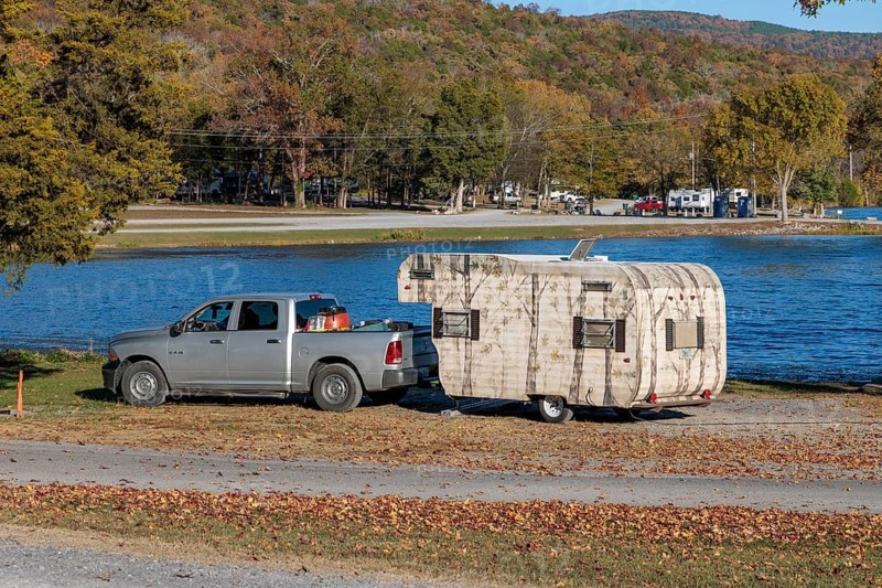 Travel trailer camper at a camp site at Marion County Park on the shore of the Nickajack Lake in Jasper, Tennessee, USA