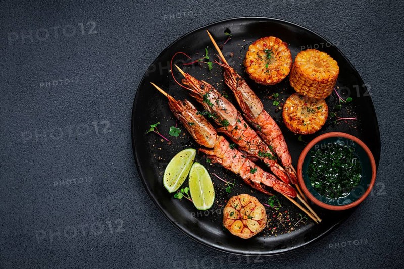 Langoustines on skewers, shrimp kebab, with fried corn, spices and herbs, homemade, no people