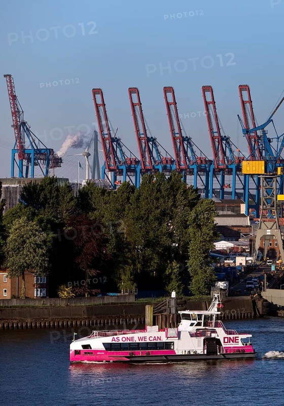 Hybrid harbour ferry Neuland of HADAG in front of the empty Blohm und Voss dry dock Elbe 17 in the port of Hamburg, Germany