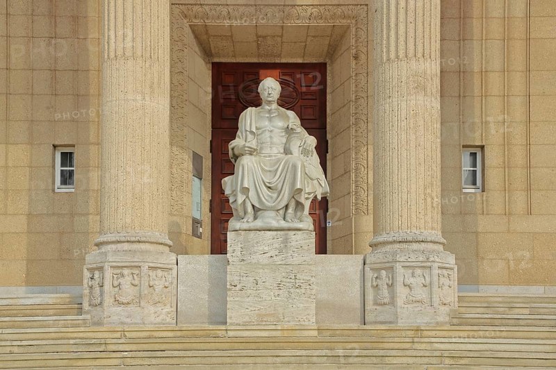 Johann Wolfgang von Goethe sitting on a throne, stone sculpture, monument, ruler, exalted, victor, triumphant, columns with fluting, Landesmuseum, city centre, Wiesbaden, Taunus, Hesse, Germany
