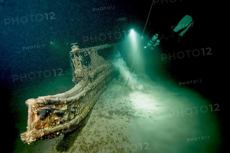Underwater image of a diver approaching a shipwreck with a light source, dive site wreck of the Jura, Lake Constance, Bottighofen, Switzerland, Münsterlingen, Germany