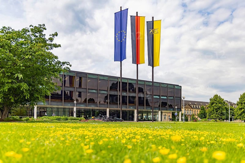 House of the state parliament of Baden-Württemberg, state parliament building in Stuttgart. Flags above the building on a session day. The Haus des Landtags was built between 1959 and 1961 according to a design by Kurt Viertel. From 2013 to 2016, the listed building was completely renovated and brought up to technical standards. Stuttgart, Baden-Württemberg, Germany
