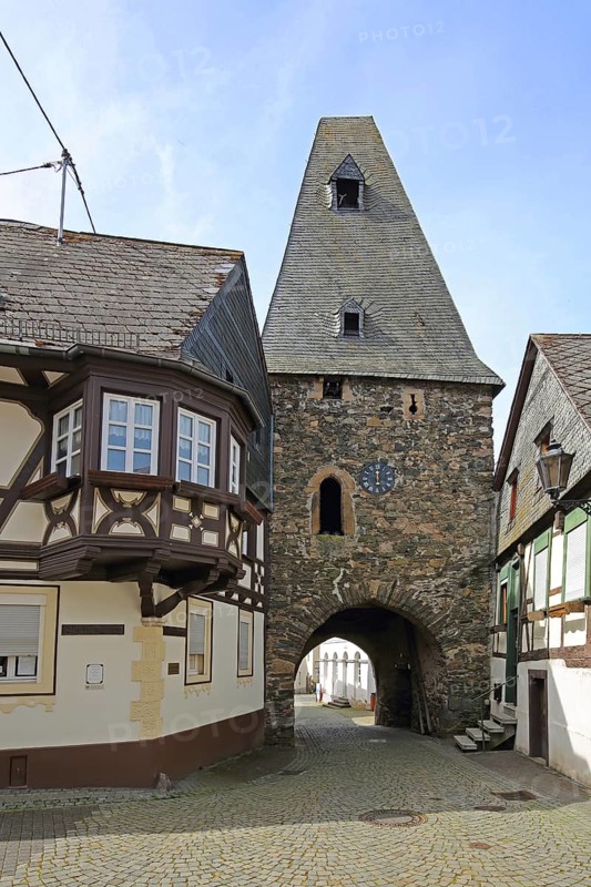 Historic clock tower and half-timbered house with oriel, landmark, town gate, town tower, Herrstein, Hunsrück, Rhineland-Palatinate, Germany