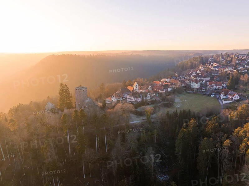 View of a village with a ruin in a hilly forest landscape at sunset, Zavelstein, district of Calw, Black Forest, Germany