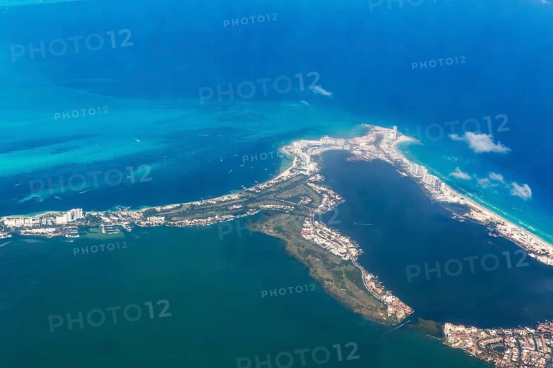 Aerial view through plane window of Caribbean coastline buildings in the hotel zone, Cancun, Quintana Roo, Yucatán Peninsula, Mexico