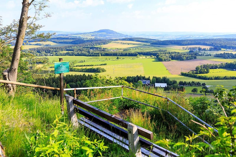 Viewpoint Schneiderfelsen with bench and view of the Pöhlberg, Erzgebirge, Saxony, Germany