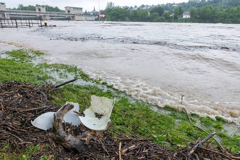 Symbolic image extreme weather, global warming, climate change, environmental pollution, plastic waste, microplastic, flood, washed up wood, barrage on the Neckar river, Aldingen, Baden-Württemberg, Germany