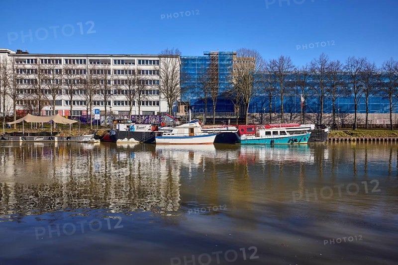 River Saar, ships, modern architecture, concrete architecture, former tax office, abstract reflections, reflections on the water surface, blue sky, cloudless, Saarbrücken, state capital, regional association Saarbrücken, Saarland, Germany