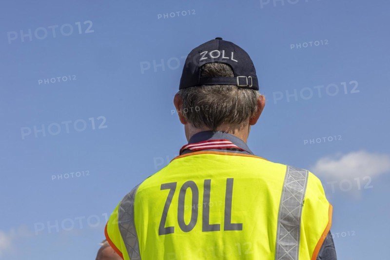 Customs officers wearing high-visibility waistcoats, Schönefeld Airport apron, Brandenburg, Germany