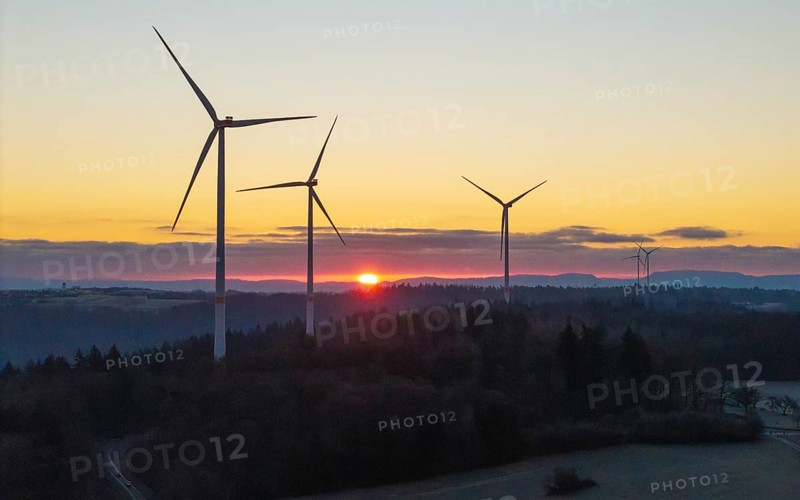 Wind turbines at sunrise with a road in the foreground, Rems Valley, Baden-Württemberg, Germany