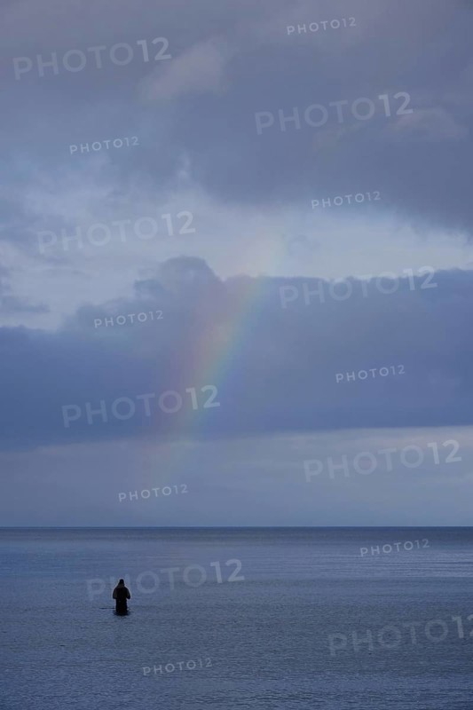 Angler and rainbow, Baltic Sea, Mecklenburg-Western Pomerania, Germany
