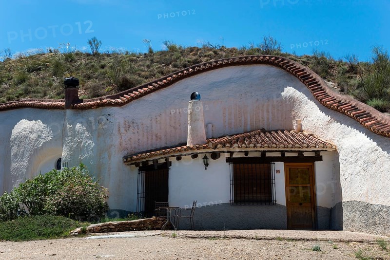 White house with charming rustic style in a hill with clear blue sky in summer, Cuevas del Zenete, cave houses, La Calahorra, Guadix, Granada province, Andalucia, Spain