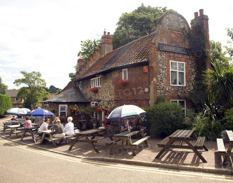 People sitting outside Adam and Eve pub, the oldest in Norwich, Norfolk, England, UK