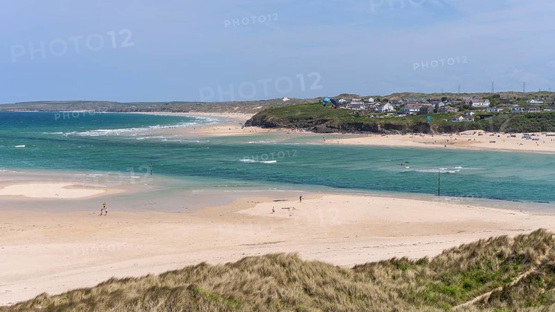 View from Hayle Sands to Hayle Beach and Riviere Towans Beach and some houses. sandy beach beach, sea, kite surfers, landscape, people on the beach. Good weather, blue sky. Hayle Beach, West Cornwall, England, Great Britain