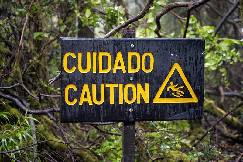 Warning sign Cuidado Caution, Attention danger of slipping, in the forest, Poás National Park, central highlands, Alajuela province, Costa Rica