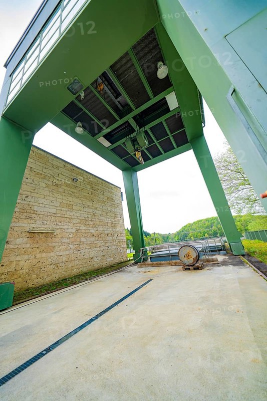 Industrial structure with green construction and machinery on an outdoor concrete floor, Glems reservoir, Swabian Alb, Germany
