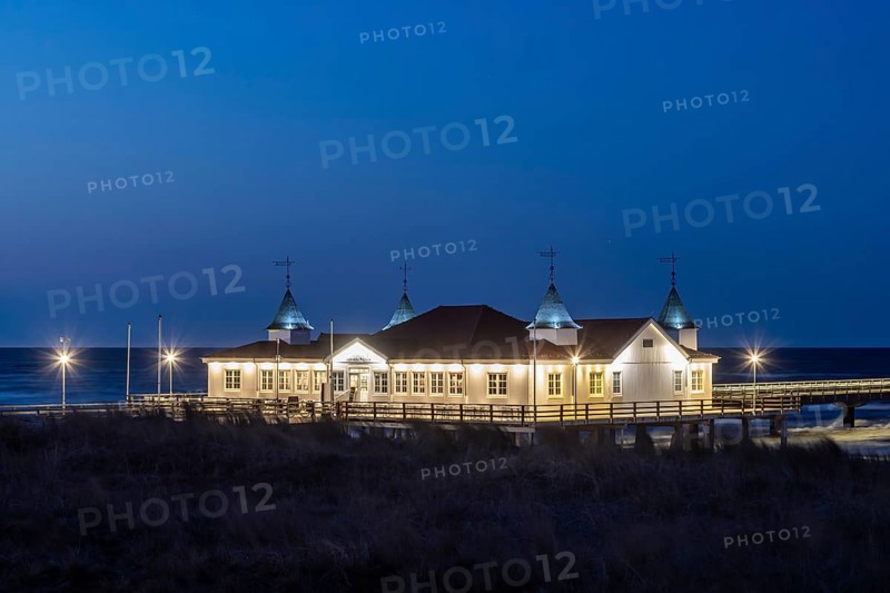 Restaurant on Ahlbeck Pier, Seebrücke Ahlbeck illuminated at dusk in the Baltic Sea on Usedom island, Mecklenburg-Vorpommern, oldest pier in Germany