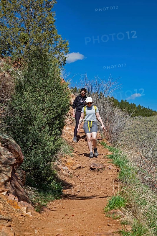 Idledale, Colorado - Hikers on the Bruin Bluff Trail in Lair o' the Bear Park. The park is part of Jefferson County Open Space in the Rocky Mountain foothills west of Denver. The park offers, hiking, fishing, and mountain biking opportunities