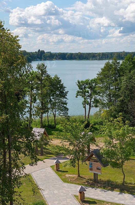 Lake with surrounding trees and well-kept path under a blue sky with clouds, view from the observation tower to the lake Ilinsk, graduation tower, spa town Milomlyn, Milomlyn, Lviv, Warmia-Masuria, Poland