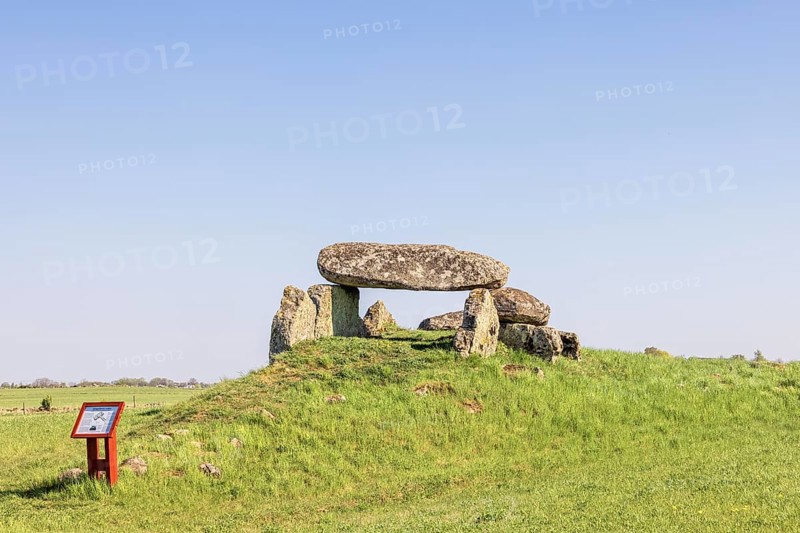 Passage grave on a hill with big boulders in a rural landscape with a clear blue sky Falköping, Luttra, Sweden