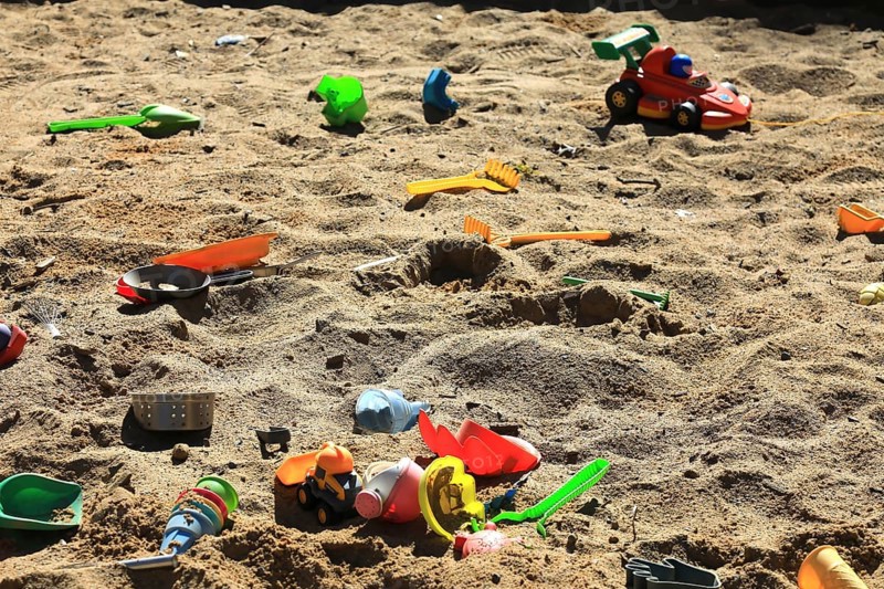 Playground, sandpit with plastic toys, vehicles, shovel