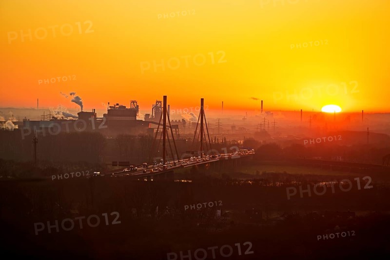 Atmospheric view of the ThyssenKrupp plant with the A 42 motorway at sunrise, Duisburg, North Rhine-Westphalia, Germany
