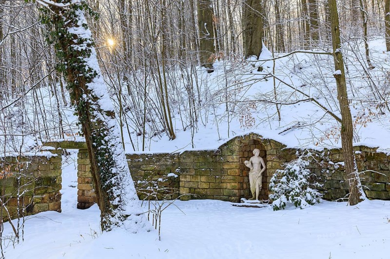 Sculpture of a woman and wall, winter in the landscape park of Dittersbach Castle, Dürrröhrsdorf-Dittersbach, Saxony, Germany