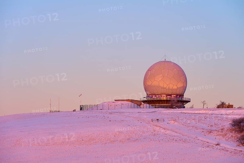 A radar station radome on a snow-covered hill at sunset with pink sky, winter, Wasserkuppe, Gersfeld, Rhön, Hesse, Germany