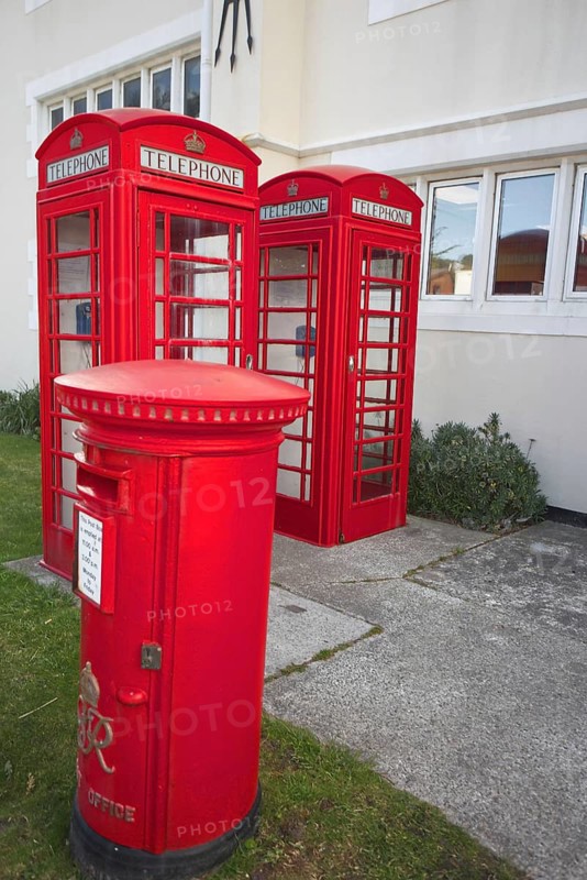 Red telephone boxes and letterbox in front of a British-style building on the Falkland Islands, Port Stanley, Falkland Islands, Argentina
