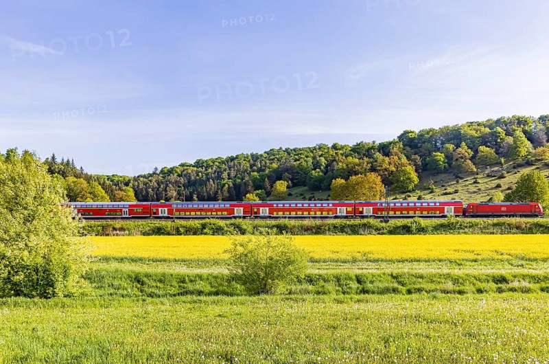 RegionalExpress RE5 to Friedrichshafen travelling over the Swabian Alb. Idyllic landscape near Lonsee in spring. Lonsee, Baden-Württemberg, Germany