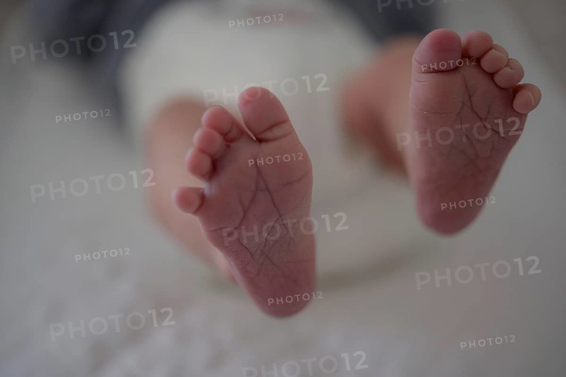 Close-up of baby's feet on a soft surface, blurred background