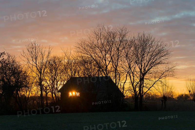 Sunset, sky burning, evening sun shining through a window of a house, house on the Dijkweg, Holwierde, Eemsdelta, Groningen, Netherlands