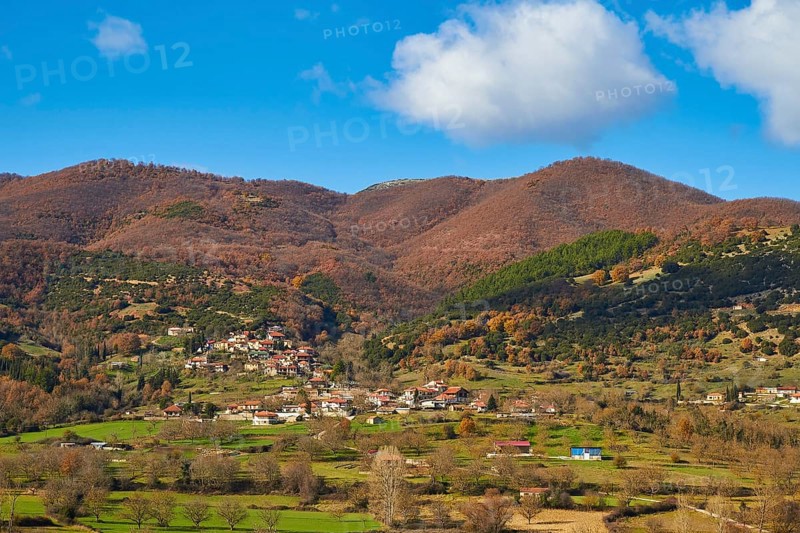 View of a village surrounded by autumnal hills and meadows, Erymanthos Mountains, northwest of the Peloponnese peninsula, Peloponnese, Greece