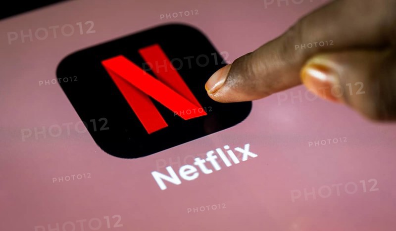 In this photo Illustration a person taps Netflix App icon on a tablet device on 24 May 2025 in New Delhi, India