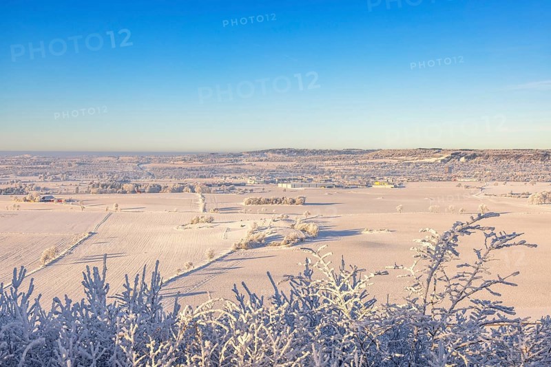 Beautiful countryside winter landscape view a cold sunny day with hoarfrost on the treetops and a blue sky, Ålleberg, Falköping, Sweden