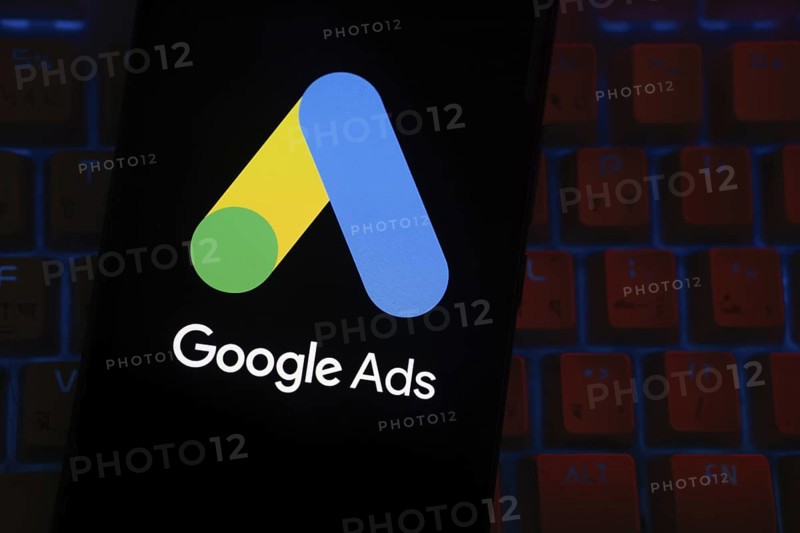 The logo of the Google Ads is displayed on a smartphone screen