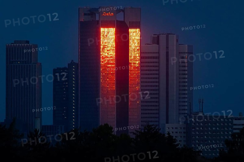 The glass façade of the 186 metre high Trianon Tower in Frankfurt am Main reflects the light of the setting sun. During the property crisis, the owner company, Geschäftshaus am Gendarmenmarkt GmbH, filed for insolvency at Frankfurt am Main Local Court, Frankfurt am Main, Hesse, Germany