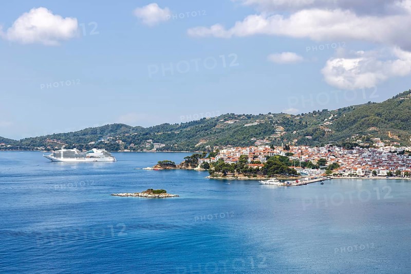 Skiathos town with cruise ship holidays by the sea on the Mediterranean island of Skiathos, Greece