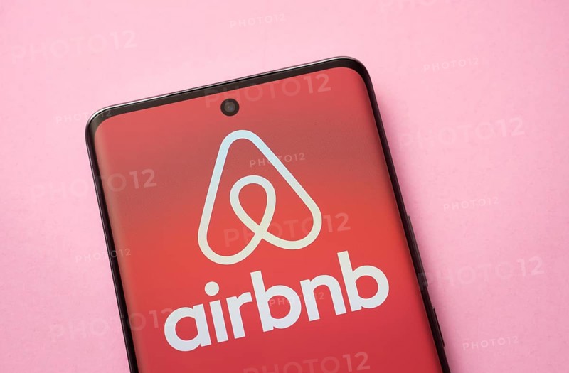 Airbnb logo is seen on a smartphone