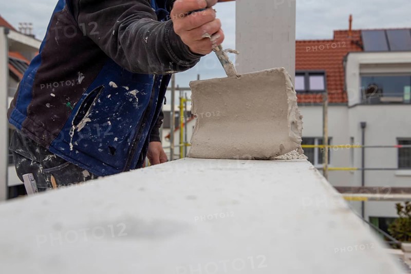 Bricklayers work on a new detached house