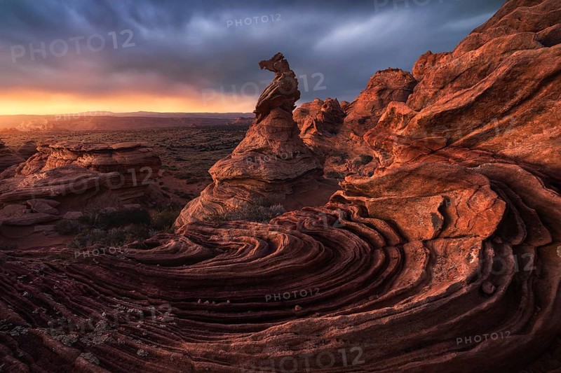 Striking rock formations captured at sunset in Coyote Buttes, Paria Canyon-Vermilion Cliffs Wilderness, showcasing the weathered sandstone against a vibrant sky in Arizona, USA