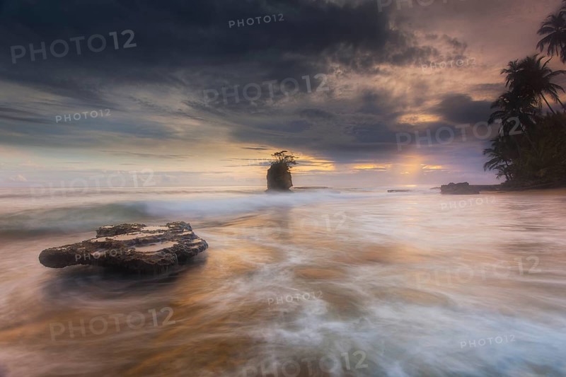 Before traveling to Costa Rica's extreme southeast to photograph the wild and isolated Gandoca/Manzanillo National Wildlife Refuge, I looked up lots of pics on Google to see what beaches might have the ingredients for a great coastal scenic. This beach, with the large exposed coral reef shelf (about the size of a large conference room table) and the scraggly tree-studded island off the coast, caught my eye. Now it was time for a little research. I assumed I wanted to shoot at sunrise since I was on the Caribbean (Atlantic) coast. Checking a great digital app called the Photographer's Ephemeris hit me with some knowledge. Because of the way Costa Rica is positioned geographically and the way this particular spot juts out from the mainland, I could actually shoot this beach with the sun in the frame at both sunrise and sunset. Amazing! But, sunset would cause a shadow on the tidal outcrop that I knew I wanted as my main foreground subject. Sunrise it was. Checking a tide chart, I found t...