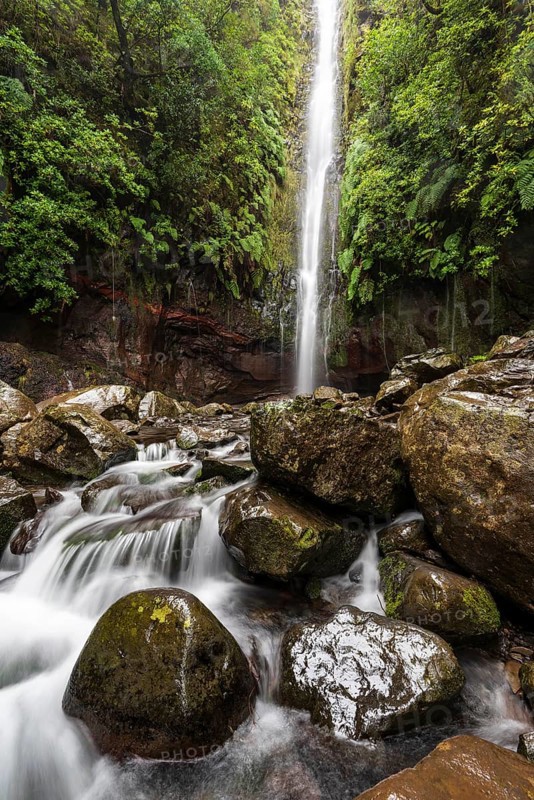 High waterfall on the Levada das 25 Fontes e Risco, surrounded by moss-covered rocks, Rabaçal nature reserve, Laurisilva laurel forest, Madeira, Portugal