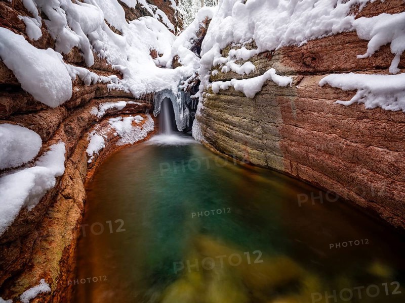 Taugl or Tauglbach flows through the snow-covered and icy red gorge, also Marmorklamm, Bad Vigaun, Tennengau, Salzburg, Austria