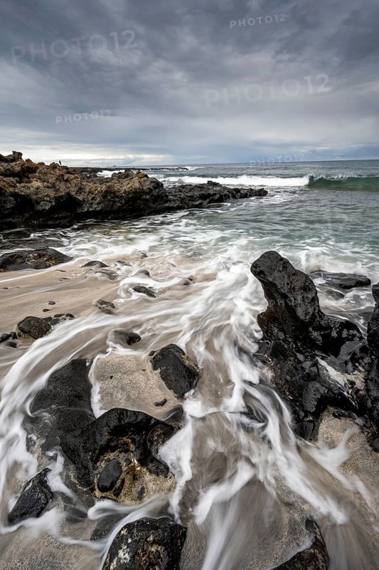 Waves blaze on the beach, rocky coast with volcanic stones, long exposure, Playa de la Pequeña, Punta Usaje, Lanzarote, Canary Islands, Spain