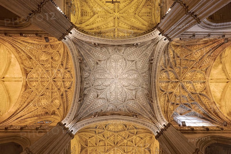 Beautifully decorated vaulted ceiling with complex symmetry and Gothic elements, Seville, Andalusia, Spain